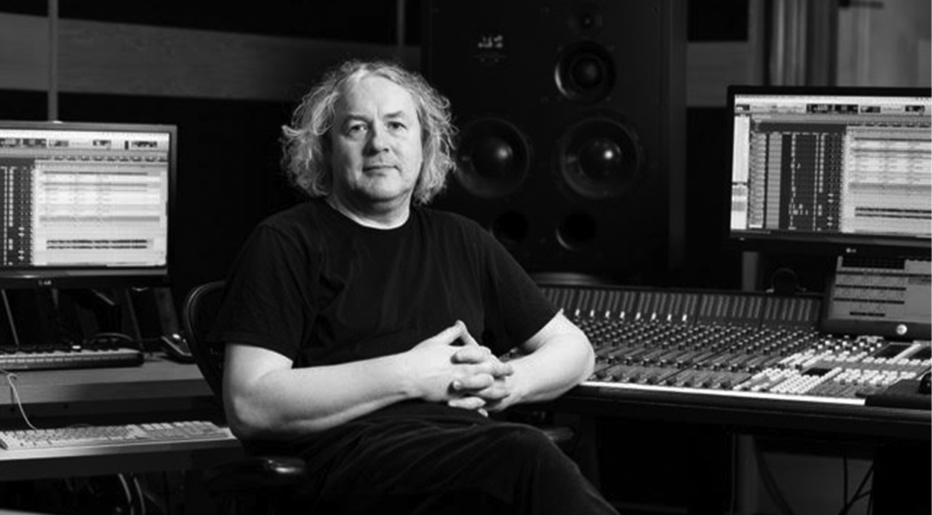 Composer Tony Doogan seated in studio.
